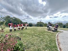 Fort McHenry Guard playing fifes and drums at Patterson Park with visitors and rangers watching