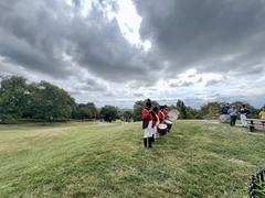 Fort McHenry Guard playing fifes and drums at Patterson Park with visitors and rangers watching