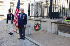 Ceremony at the Battle Monument with flags and attendees