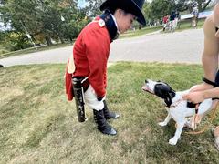 Living Historian greeting a dog at Patterson Park