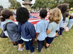Living Historians and Park Rangers teaching children about flags at Patterson Park