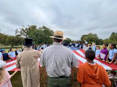 Living historians and park rangers teaching children about flags at Patterson Park