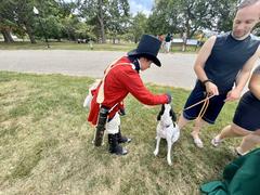 Living historian at Patterson Park with a dog