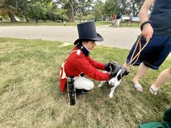 Living historian holding a dog at Patterson Park