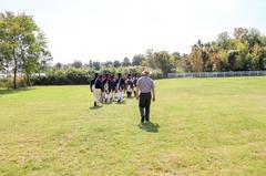 Living historians and Park Rangers walking towards the natural shoreline at Todd's Inheritance historic site