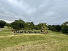 Children marching around Patterson Park with living historians and Fort McHenry Guard in historical attire