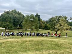 Fort McHenry Guard and Living Historians marching with children at Patterson Park
