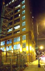 Night view looking north along Flatbush Avenue Extension and across Chapel Street showing former Sperry Corporation factory now part of City University of New York
