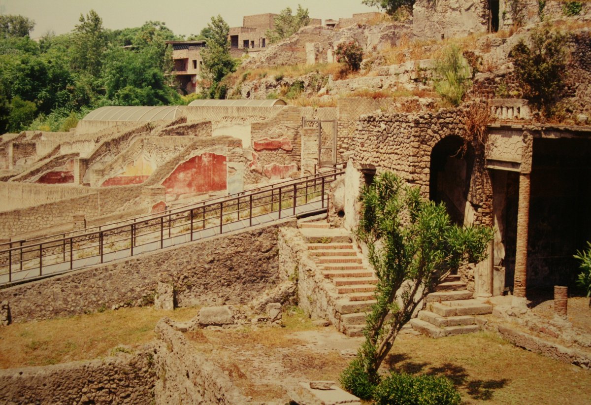 Ancient ruins of Pompeii with preserved walls and structures under blue sky