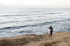 Sunset cliffs at San Diego coastline during golden hour with ocean waves and rocky shore