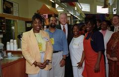 President Bill Clinton with shop owners and vendors at Sweet Auburn Market in Atlanta
