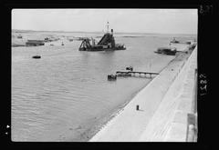View of Isma'lia canal in Egypt with a dredger working, looking south towards the war monument