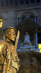 Statue of a soldier at the Cenotaph in Martin Place Sydney against clear blue sky