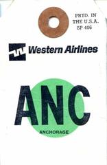 Vintage Western Airlines bag tag from 1972 with destination Anchorage on a yellow background