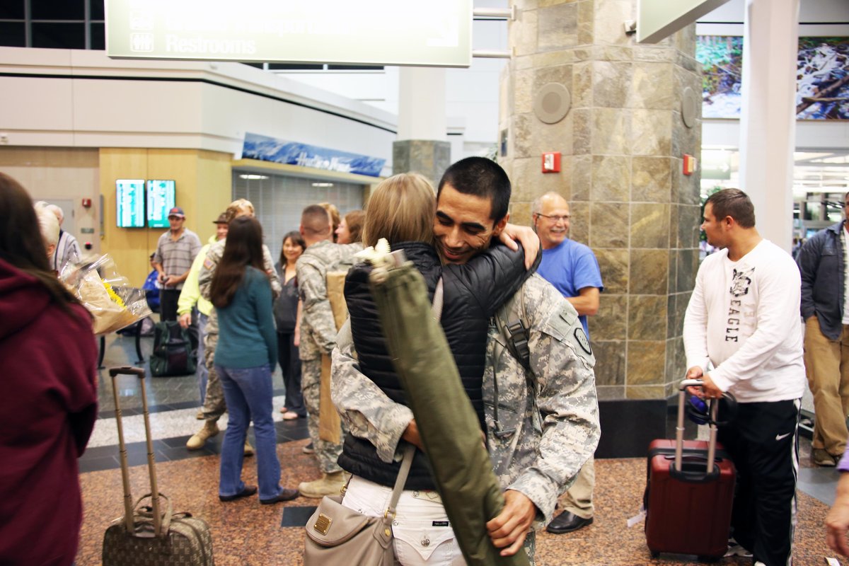 Alaska Army National Guardsman Sgt. Ulysses Cortez embraces his girlfriend Jenelle Bennett at Ted Stevens International Airport after 11-month military deployment to Guantanamo Bay