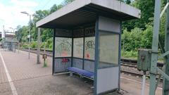 Small passenger waiting area at Bahnhof Grötzingen with benches and shelter