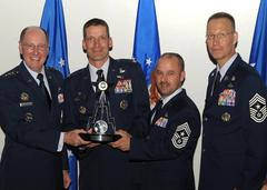 General C. Robert Kehler presenting the Inaugural Cyber Award to Col. Robert Skinner and Command Chief Master Sergeant Michael Whetsell at Peterson Air Force Base