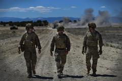 U.S. Air Force Explosive Ordnance Disposal airmen discussing training after detonating C4 explosive at Fort Carson Air Burst Range