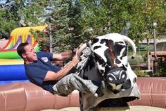 Col. Todd Moore riding a mechanical bull during the Air Force's 71st birthday celebration at Peterson Air Force Base
