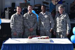 Senior leaders of the 21st Space Wing cutting a birthday cake celebrating the Air Force's 71st birthday at Peterson Air Force Base