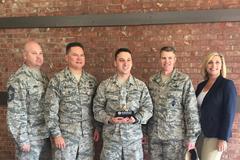 Senior Airman Dennis Hoffman receiving Military Graphic Designer of the Year 2017 award at Peterson Air Force Base