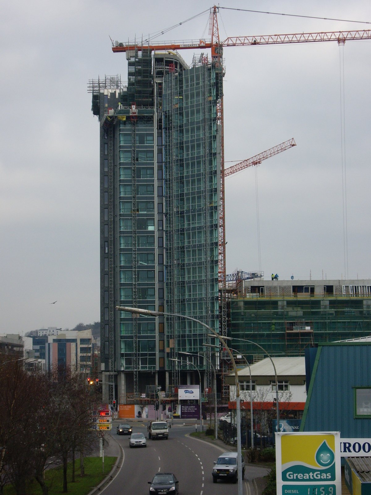Elysian building under construction in Cork from cable-stayed pedestrian bridge
