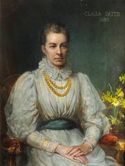 Portrait of Clara Pater, a woman with dark hair wearing a black dress with a lace collar