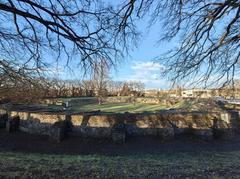 Ancient Aquincum Amphitheater ruins in Budapest under a clear blue sky