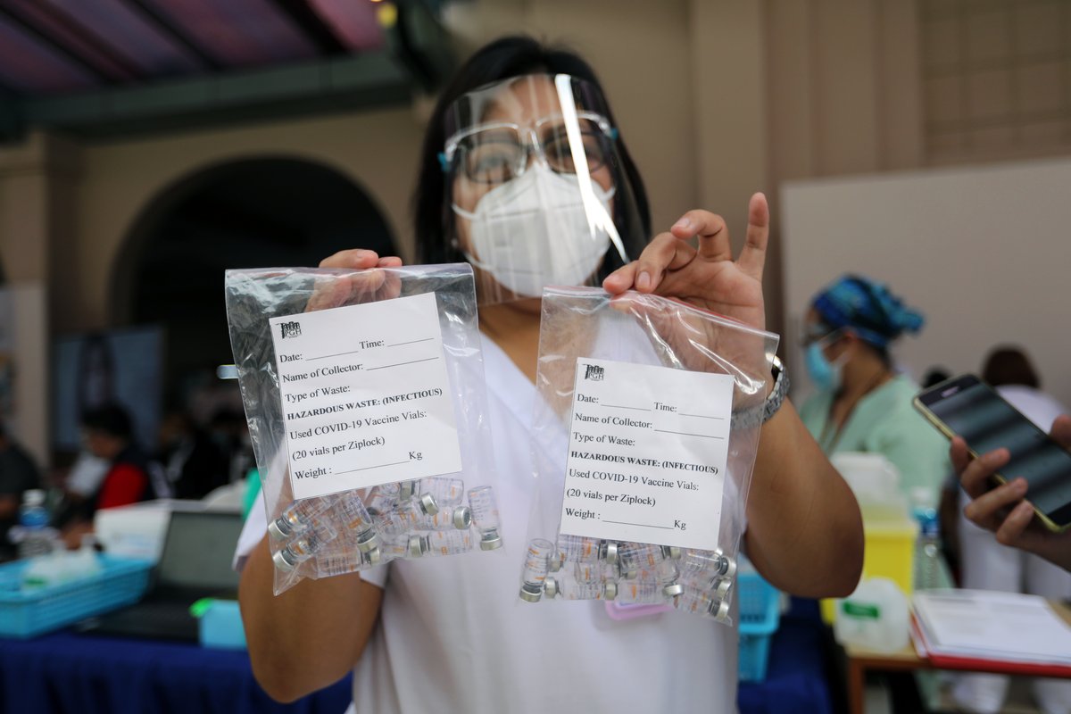 Health worker showing empty CoronaVac vaccine vials during vaccination of frontline healthcare workers at UP-PGH