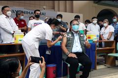 Vaccine czar Carlito Galvez Jr. receiving CoronaVac vaccine with thumbs-up at UP-PGH Manila