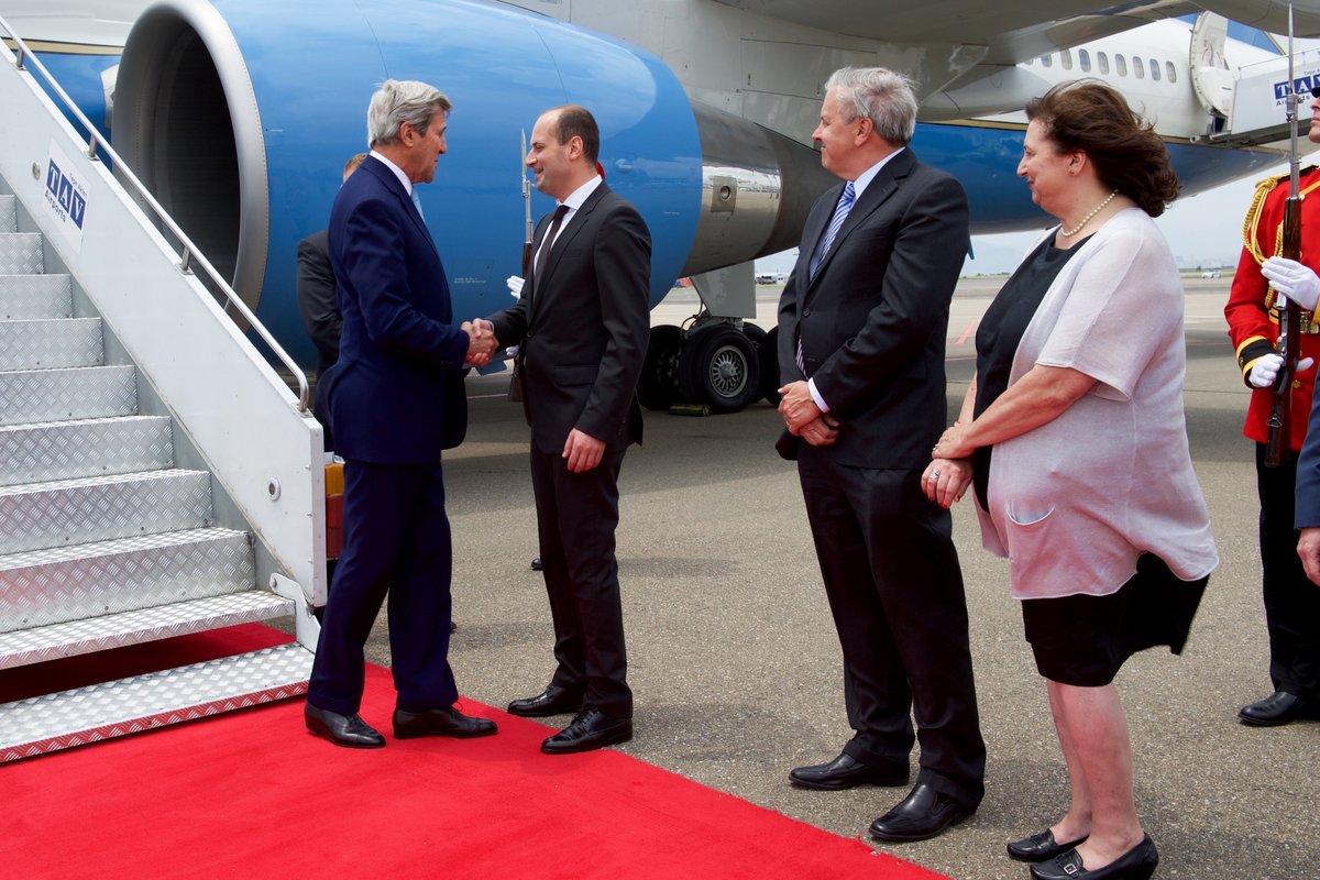 U.S Secretary of State John Kerry shaking hands with Georgian Foreign Minister Mikhail Janelidze at Tbilisi International Airport on July 6, 2016