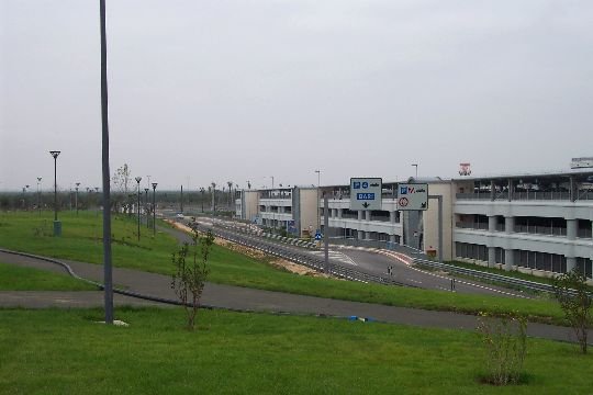 Exterior view of Bari airport multi-storey car park building under clear sky
