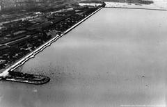 Aerial view of Puerto Madero and Balneario Costanera Sur with Espigón Plus Ultra crowded with people in 1935
