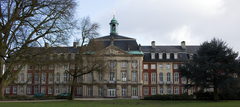 Rear view of the Fürstbischöfliches Schloss in Münster with historic architecture and greenery
