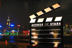 Avenue of Stars in Hong Kong at night with the city skyline and Victoria Harbour