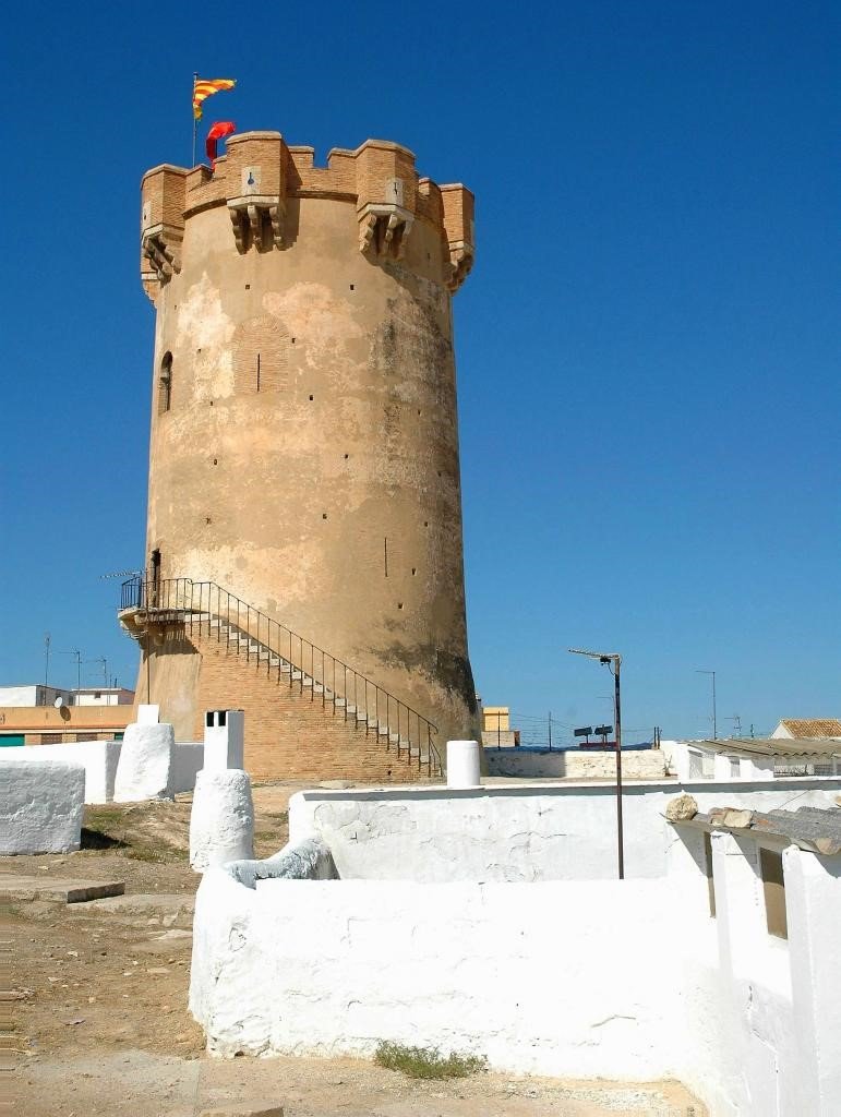 Aboquera tower in Paterna with stone construction and a rugged wall background