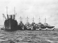 USS Markab destroyer tender with five destroyers alongside in Pacific anchorage circa 1944-1945