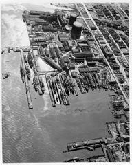 Aerial view of Bethlehem Union Iron Works shipyard in 1945 showing numerous buildings, docks, and ships under construction or repair