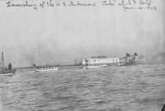 USS Pike submarine afloat at Union Iron Works in San Francisco after launching in 1903 with Navy pulling boats nearby