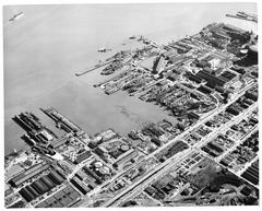 Aerial view of Bethlehem Union Iron Works shipyard with multiple large ships and cranes in San Francisco 1945