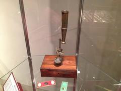 Revolutionary War era brass microscope on wood stand