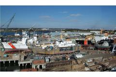 United States Coast Guard vessels docked at a shipyard