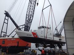 Coast Guard patrol boat IBIS being hoisted by a crane at Coast Guard Yard Baltimore
