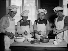 Black and white gelatin negative photograph of boys in a school kitchen class in Uppsala, 1943