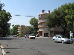 Intersection of Pres Masaryk and Alejandro Dumas streets in Polanco, Mexico City with modern buildings and street traffic