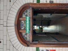 Interior view of Victoria Baths in Manchester featuring ornate tiling, large windows, and vintage swimming pool area