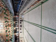 Interior view of Victoria Baths in Manchester, showcasing ornate design with tiled walls and stained glass windows