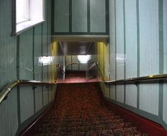 View down Victorian-style staircase inside London's Victoria Palace Theatre from the balcony level