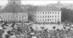 Fair day at Vodnik Square in 1927 with historic buildings and people gathering