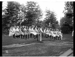 Large group of children and a woman on a seesaw in Volunteer Park, Seattle, early 1900s